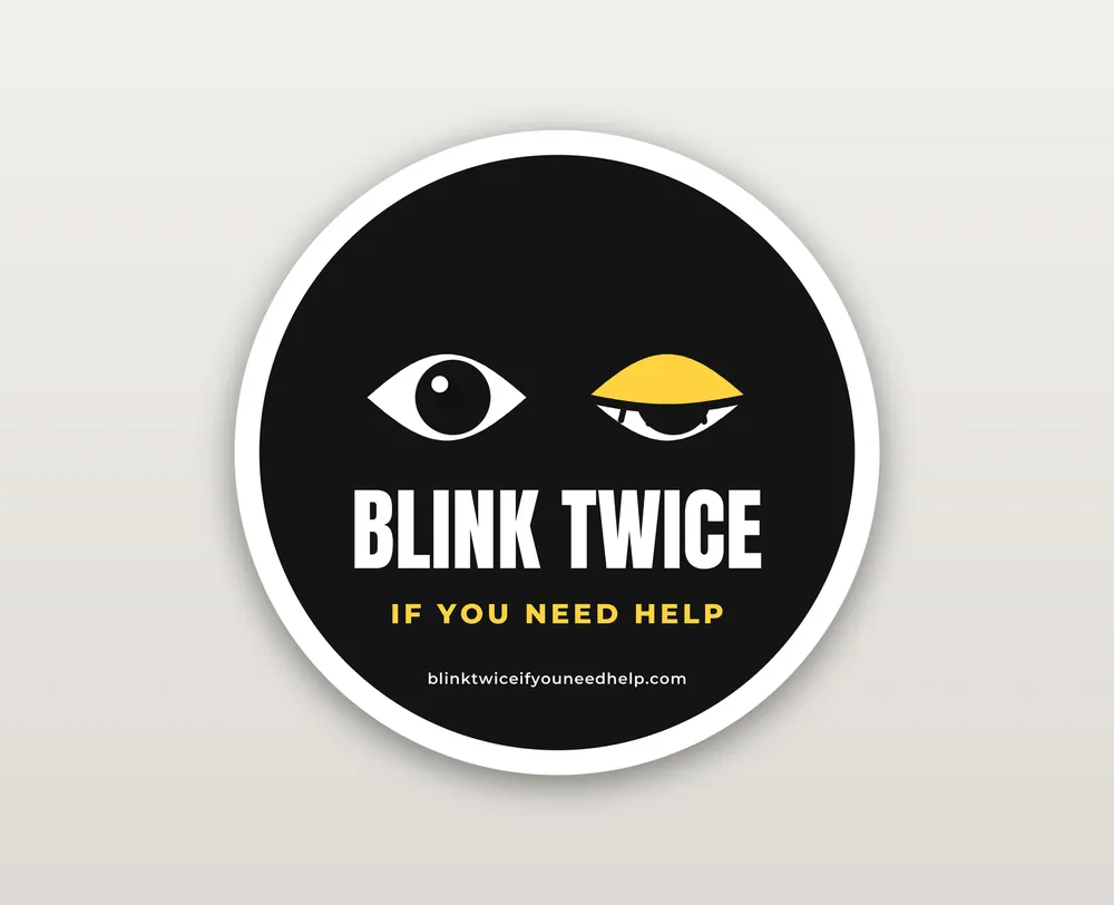 Die-cut sticker of two cartoon eyes mid-blink